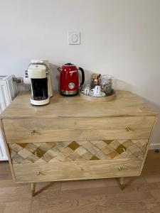 a wooden dresser with a coffee maker on top of it at Ins apartment - 2 bedrooms - metro parking prive in Bagnolet