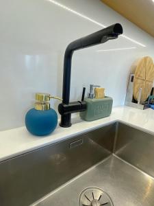 a kitchen sink with a faucet on a counter at Ins apartment - 2 bedrooms - metro parking prive in Bagnolet +24 photos