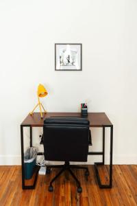 an office desk with a black chair and a lamp at Loft 302 - The William - Sunlit - Above Carrigans in Birmingham