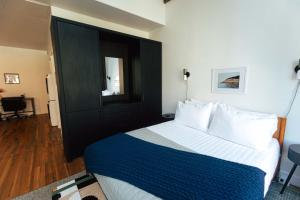 a bedroom with a bed with a blue and white comforter at Loft 302 - The William - Sunlit - Above Carrigans in Birmingham