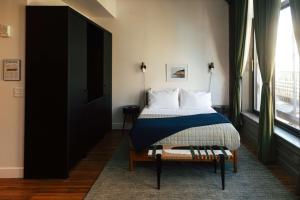 a bedroom with a bed and a large window at Loft 302 - The William - Sunlit - Above Carrigans in Birmingham +35 photos