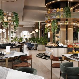 a restaurant with tables and chairs and a buffet at MOVENPICK HOTEL AL ZAYTOON BAGHDAD in Baghdad