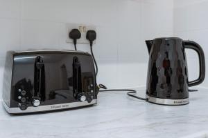 a toaster and a coffee pot sitting on a counter at Immingham Contractors stay in Immingham