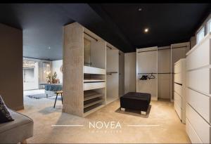 a living room with a couch and a chair at L'Écrin des Greens in Dommartin +25 photos