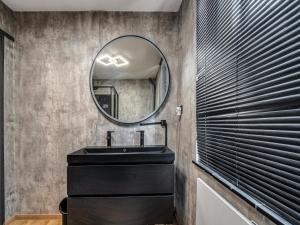 a bathroom with a black sink and a mirror at Dog-Friendly Stay in Valkenburg in Valkenburg +33 photos
