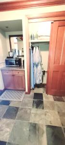 a kitchen with a door open to a kitchen with a counter at Dav's Slopeside King Studio -- Resort & Spa at Everline in Olympic Valley