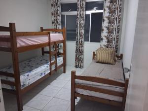 En eller flere senge i et værelse på Espaço Praia do Morro