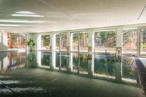a large swimming pool in a building with windows at Maison Poluc - Chiaro di Luna in Champoluc +19 photos
