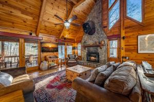 a living room with a couch and a fireplace at Merlot Chateau - Views, New Hot Tub, Fire Pit, Game Room, Wi-Fi - Mins to Blue Ridge in Morganton