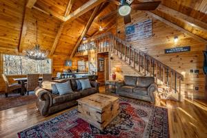 a living room with couches and a staircase in a cabin at Merlot Chateau - Views, New Hot Tub, Fire Pit, Game Room, Wi-Fi - Mins to Blue Ridge in Morganton +87 photos