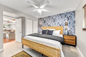 a bedroom with a large bed with a ceiling fan at Beach Walk Cottage - 451 in Siesta Key +52 photos