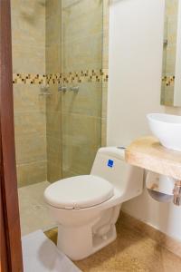 a bathroom with a toilet and a sink and a shower at Hotel Casa Centenario Getsemaní in Cartagena de Indias