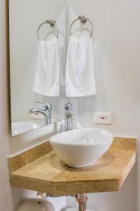 a bathroom with a white sink and a mirror at Hotel Casa Centenario Getsemaní in Cartagena de Indias