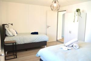 a bedroom with two beds and a mirror at Ferienwohnung mit Free Parking in Romanshorn