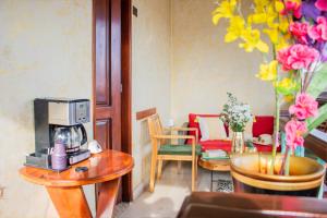 a room with a table with a coffee maker on a table with a coffee machine at Hotel Casa Centenario Getsemaní in Cartagena de Indias +28 photos