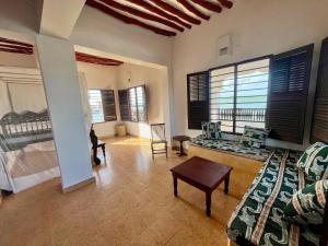 a living room with a bed and a couch at Mafazy House in Lamu