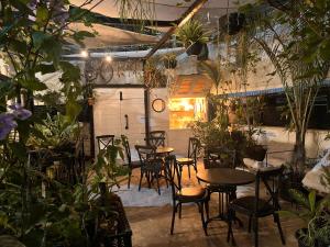 a group of tables and chairs in a room with plants at Yona 8 in Tel Aviv