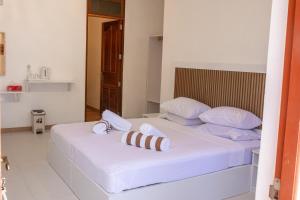 a bedroom with a bed with towels on it at Velana View at Mathiveri in Mathiveri