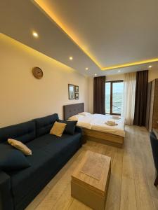 a living room with a couch and a bed at Milmari apartman SAN-28 in Kopaonik +37 photos