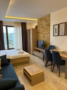 a hotel room with a bed and a living room at Milmari apartman SAN-28 in Kopaonik