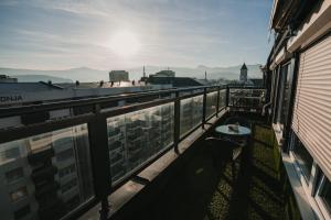 a balcony with a table and a view of the city at TheLuxPenthouseBugojno in Bugojno