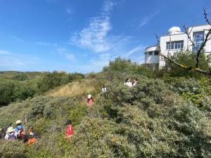 a group of people walking up a hill at Villa de Panne 6 bedrooms in De Panne