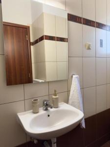 a bathroom with a white sink and a mirror at Afroditi's Apartment Superb View in Gythio +48 photos