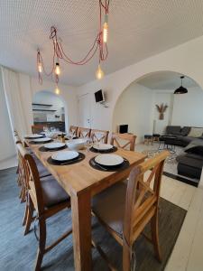 a dining room with a large wooden table and chairs at Haus de Panne 6 bedrooms in De Panne