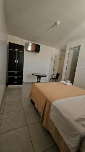 a hotel room with a bed and a table at Hotel costa del Sol Marcona in San Juan de Marcona +6 photos