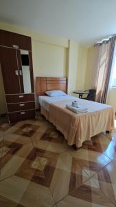 a bedroom with a large bed and a dresser in it at Hotel costa del Sol Marcona in San Juan de Marcona