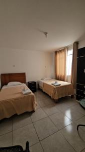 a bedroom with two beds and a window at Hotel costa del Sol Marcona in San Juan de Marcona