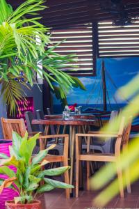 a restaurant with a table and chairs and a boat at Hotel Casa Centenario Getsemaní in Cartagena de Indias