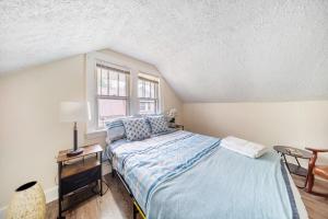 a bedroom with a bed and a window at Cuyahoga Falls 3 bedroom 2 bath in Cuyahoga Falls