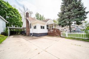 a white house with a white fence and a driveway at Cuyahoga Falls 3 bedroom 2 bath in Cuyahoga Falls