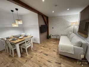 a living room with a table and a couch at Apartamenty For You in Bystrzyca Kłodzka