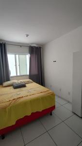 Postel nebo postele na pokoji v ubytování Quarto e banheiro privativo com espaços compartilhados próx a praias