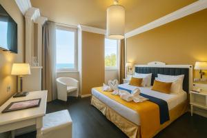 a hotel room with a bed and a desk at Greif Hotel & Spa in Trieste +124 photos