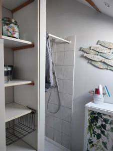 Vieille-Église-en-YvelinesLe petit grenier de la Quoiqueterie的浴室铺有白色瓷砖,设有步入式淋浴间。