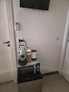a coffee maker sitting on top of a microwave at Cattedrale Central Rooms in Palermo