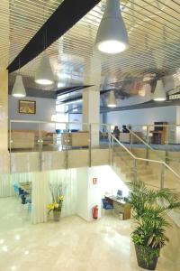 an office with a staircase and tables and chairs at Hotel Murrieta in Logroño