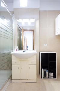 a bathroom with a sink and a mirror at Atlantic & Teide Views Penthouse in Puerto de la Cruz