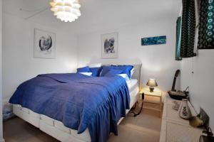a bedroom with a bed with a blue comforter at 15515-Asnaes-Klintebakken-10 in Høve Strand