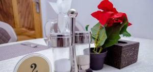 a table with a candle and a flower in a vase at BENJY palace hôtel in Matadi