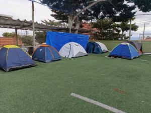 Eine Gruppe von vier Zelten auf einem Feld in der Unterkunft Pousada São João Batista in Cachoeira Paulista