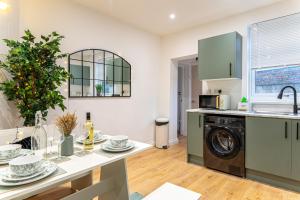 a kitchen with a washer and dryer at Cosy Corner in Derby