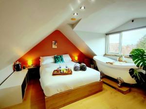 a bedroom with a bed and a bath tub and a sink at Durham Hot Tub - Steam Spa - Eco Retreat - Pizza Oven - Log Burner - Pets Ok - Garden in Langley Park