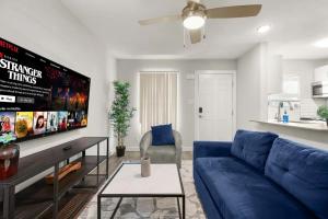 a living room with a blue couch and a tv at ATX Casa Tranquila in Austin +5 photos