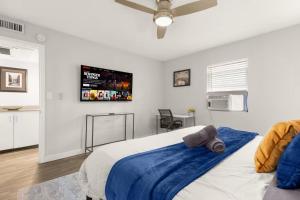 a bedroom with a bed with a tv on the wall at ATX Casa Tranquila in Austin
