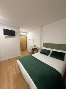 Ένα ή περισσότερα κρεβάτια σε δωμάτιο στο Stay In Vila Real Apartments