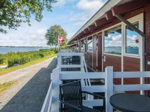 a porch of a house with chairs and a table at 6 person holiday home in Aabenraa in Aabenraa +25 photos
